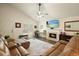 Living room featuring vaulted ceilings, a cozy fireplace, and comfortable leather sofa at 123 Stoneforest Dr, Woodstock, GA 30189