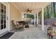 Inviting covered patio with ceiling fan, grill, and comfortable seating area at 123 Stoneforest Dr, Woodstock, GA 30189