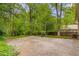 Large concrete patio surrounded by mature trees and lush greenery in the backyard at 1460 Briarcliff Ne Rd, Atlanta, GA 30306