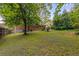 Green backyard showcasing the exterior of the brick home and a lush lawn at 1460 Briarcliff Ne Rd, Atlanta, GA 30306