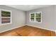 Bright bedroom with hardwood floors and windows offering views of the surrounding trees at 1460 Briarcliff Ne Rd, Atlanta, GA 30306