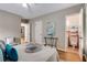 Bedroom view with hardwood flooring, gray walls, a decorative side table, and an ensuite at 1460 Briarcliff Ne Rd, Atlanta, GA 30306