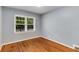 A cozy bedroom with hardwood floors and a window offering natural light at 1460 Briarcliff Ne Rd, Atlanta, GA 30306
