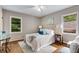 Cozy bedroom with hardwood floors, two windows, and neutral decor at 1460 Briarcliff Ne Rd, Atlanta, GA 30306