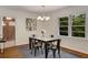 Dining area featuring a modern light fixture, and a large window with views of the wooded yard at 1460 Briarcliff Ne Rd, Atlanta, GA 30306