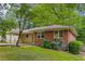Side view of a brick home with well-maintained landscaping, large windows and an attached carport at 1460 Briarcliff Ne Rd, Atlanta, GA 30306
