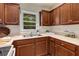 Kitchen featuring wood cabinets, updated countertops, and stainless steel sink under window at 1460 Briarcliff Ne Rd, Atlanta, GA 30306