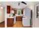 Efficient kitchen with wood cabinets, white appliances, and a stacked washer and dryer at 1460 Briarcliff Ne Rd, Atlanta, GA 30306