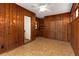 Sun room featuring wood paneling, built-in shelves, and access to additional rooms at 1460 Briarcliff Ne Rd, Atlanta, GA 30306