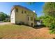 Back of home with a well-maintained lawn, a deck with railings, and double garage doors at 1820 Lyon Sw Ave, Atlanta, GA 30331
