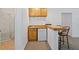 Finished basement bar with wood countertops, mini-fridge, bar seating and adjacent shower stall at 1820 Lyon Sw Ave, Atlanta, GA 30331