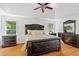 This primary bedroom is spacious with hardwood floors, tray ceilings, and lots of furniture at 1820 Lyon Sw Ave, Atlanta, GA 30331