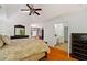 This primary bedroom offers an attached bath, a ceiling fan, and lots of light from outside at 1820 Lyon Sw Ave, Atlanta, GA 30331