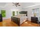 This primary bedroom is spacious with hardwood floors, tray ceilings, and large windows at 1820 Lyon Sw Ave, Atlanta, GA 30331