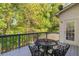 Back deck area of home featuring room for table and chairs and views of the private wooded backyard at 1820 Lyon Sw Ave, Atlanta, GA 30331