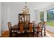 Formal dining room featuring hardwood floors, bay window, and a statement chandelier at 1820 Lyon Sw Ave, Atlanta, GA 30331