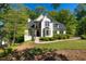 Beautiful two-story home with a lush front lawn, manicured bushes, and a driveway at 1820 Lyon Sw Ave, Atlanta, GA 30331