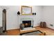 Living room fireplace with hearth, decorative mirror, and hardwood flooring at 1820 Lyon Sw Ave, Atlanta, GA 30331