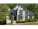 Charming stucco home featuring a well-manicured lawn, arched windows, and a stone accent entry at 1820 Lyon Sw Ave, Atlanta, GA 30331