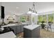 Open kitchen with gray cabinets and breakfast nook overlooking the backyard at 1820 Lyon Sw Ave, Atlanta, GA 30331