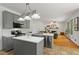 Open kitchen with island, gray cabinets, stainless appliances, and view to the living room at 1820 Lyon Sw Ave, Atlanta, GA 30331