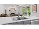 Modern kitchen island and stainless steel sink with view to the fireplace at 1820 Lyon Sw Ave, Atlanta, GA 30331