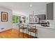 Open-concept kitchen with grey cabinets, stainless appliances, hardwood floors and breakfast bar seating at 1820 Lyon Sw Ave, Atlanta, GA 30331