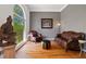 Elegant living room with hardwood floors, large arched window, and a sophisticated decor creates a warm atmosphere at 1820 Lyon Sw Ave, Atlanta, GA 30331