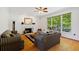 Cozy living room featuring hardwood floors, a fireplace, and large windows providing natural light at 1820 Lyon Sw Ave, Atlanta, GA 30331