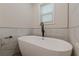 Contemporary bathroom highlighting a sleek, standalone soaking tub and stylish finishes at 214 Adeline Nw Ave, Atlanta, GA 30314