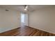 A minimalist bedroom featuring hardwood floors, neutral walls, a ceiling fan, and a closet at 214 Adeline Nw Ave, Atlanta, GA 30314