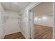 Walk-in closet with ample shelving and storage space, plus wood-look floors at 214 Adeline Nw Ave, Atlanta, GA 30314