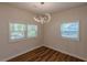 This dining room features plank floors, two windows, modern light fixture, and white walls at 214 Adeline Nw Ave, Atlanta, GA 30314