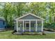 Inviting home exterior featuring a quaint front porch with hanging plants and fresh landscaping at 214 Adeline Nw Ave, Atlanta, GA 30314