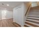 Newly renovated hallway leading to bedrooms and bathrooms, featuring wood floors, white doors, and a staircase at 214 Adeline Nw Ave, Atlanta, GA 30314