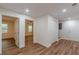 An inviting hallway with plank floors leading to bedrooms and bathrooms, offering ample closet space at 214 Adeline Nw Ave, Atlanta, GA 30314