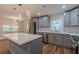 Bright kitchen featuring stainless steel appliances, an island, and unique lighting at 214 Adeline Nw Ave, Atlanta, GA 30314