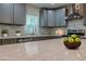 Well-lit kitchen featuring stainless steel appliances, marble countertops, and grey cabinets at 214 Adeline Nw Ave, Atlanta, GA 30314