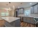 Bright kitchen with a large island, stainless steel appliances, and modern pendant lighting at 214 Adeline Nw Ave, Atlanta, GA 30314