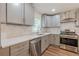 Well-appointed kitchen with gray cabinetry, stainless steel appliances, and quartz countertops at 214 Adeline Nw Ave, Atlanta, GA 30314