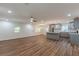Open-concept kitchen and living area with gray cabinets, stainless steel appliances, and hardwood floors at 214 Adeline Nw Ave, Atlanta, GA 30314