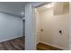 The laundry closet features plank floors, white walls, and new electrical wiring at 214 Adeline Nw Ave, Atlanta, GA 30314