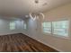 Bright living room featuring hardwood floors, a modern light fixture, and large windows at 214 Adeline Nw Ave, Atlanta, GA 30314