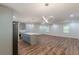 Open-concept living space featuring wood floors, modern lighting, and a kitchen island at 214 Adeline Nw Ave, Atlanta, GA 30314