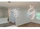 Open-concept living space with wood floors, gray cabinets, and modern pendant lighting at 214 Adeline Nw Ave, Atlanta, GA 30314