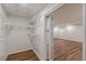 Walk-in closet features adjustable shelving and easy access to bonus room at 214 Adeline Nw Ave, Atlanta, GA 30314