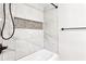 Modern bathroom featuring marble-like tile, a recessed shower niche, and dark bronze fixtures at 2554 Gordon Se Cir, Smyrna, GA 30080