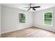 Bright bedroom with hardwood floors, ceiling fan, and natural light from the two windows at 2554 Gordon Se Cir, Smyrna, GA 30080