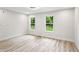 A bedroom featuring wood floors and two windows with a green outdoor view at 2554 Gordon Se Cir, Smyrna, GA 30080