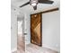 A bedroom with a sliding barn door and open door at 2554 Gordon Se Cir, Smyrna, GA 30080